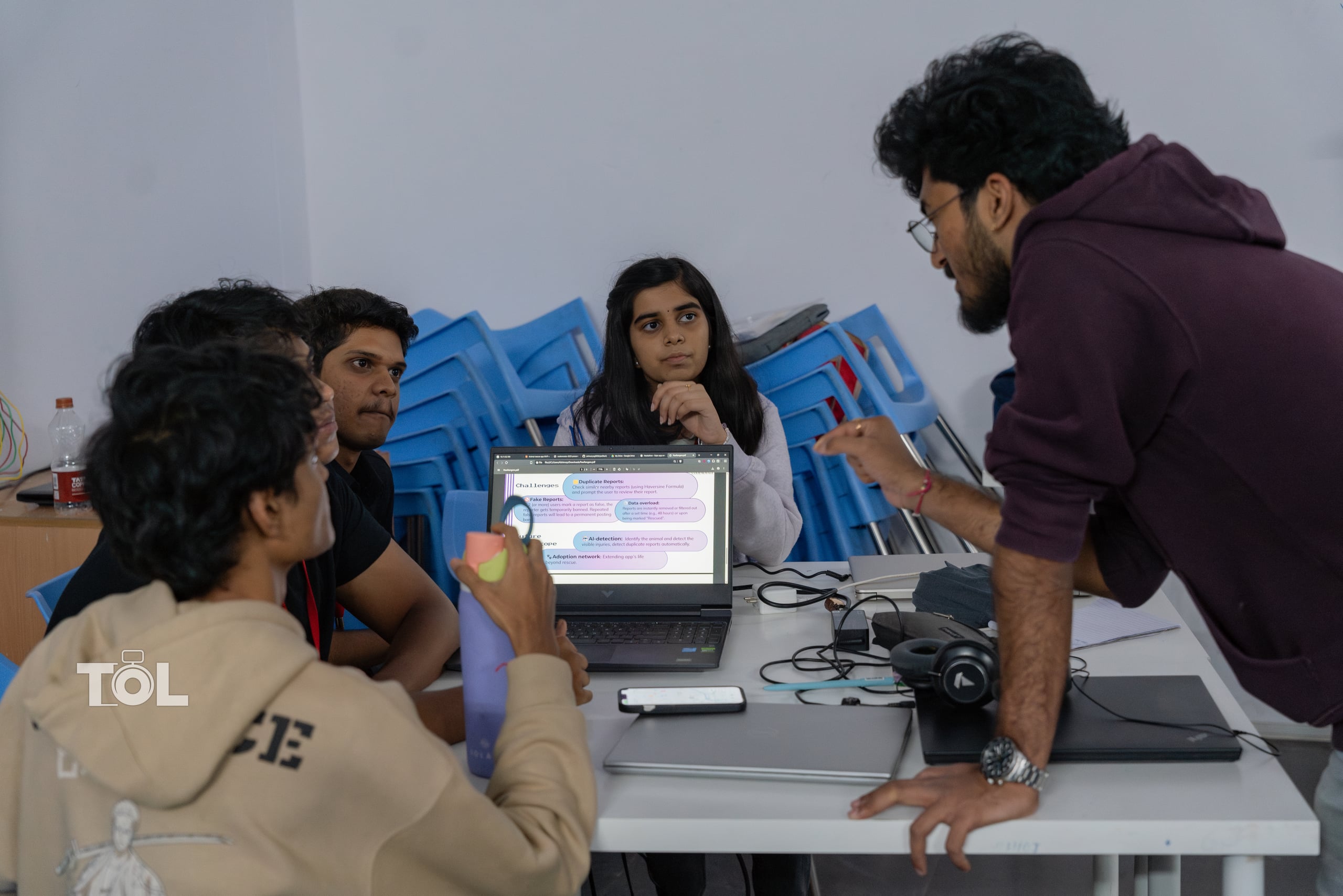A Codenovate team collaborating around a laptop