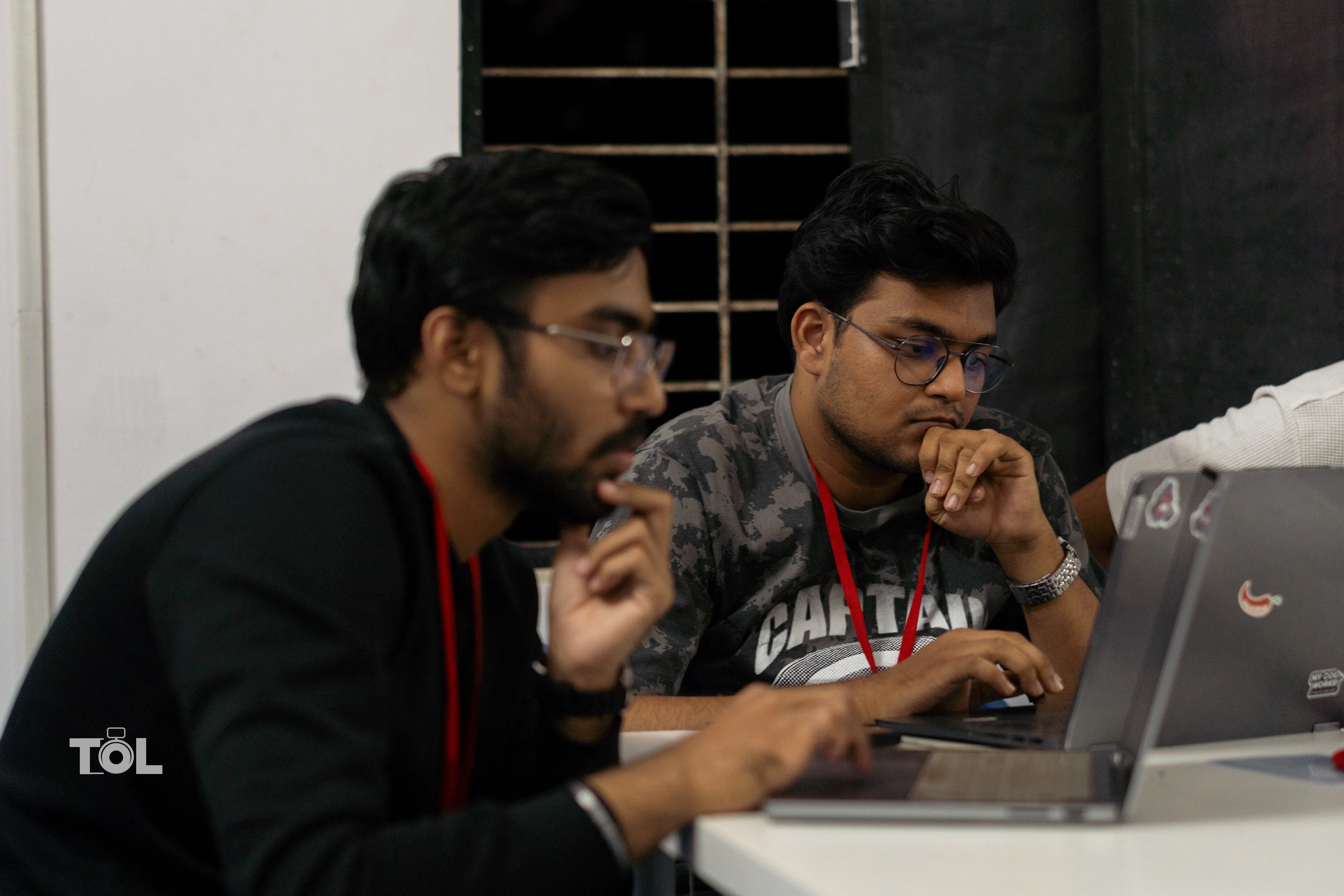 Codenovate participants collaborating around a laptop